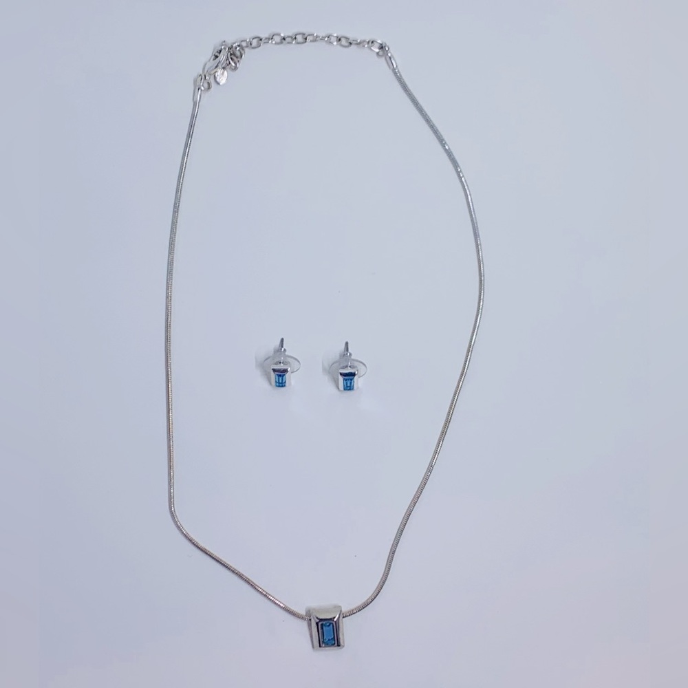 Silver necklace and matching stud earrings with blue stone